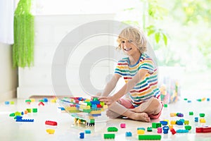 Child playing with toy blocks. Toys for kids