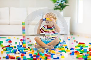 Child playing with toy blocks. Toys for kids