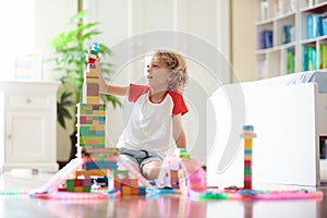 Child playing with toy blocks. Toys for kids