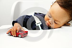 Child playing with toy car