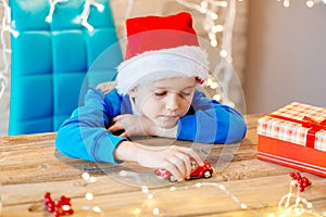 Child playing with toy from Santa Claus at home