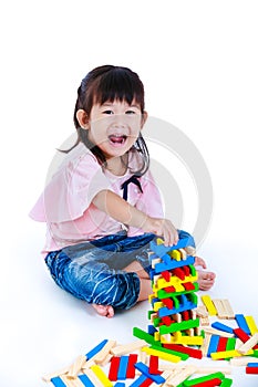 Child playing toy wood blocks, isolated on white background.