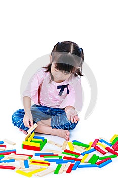 Child playing toy wood blocks, isolated on white background.