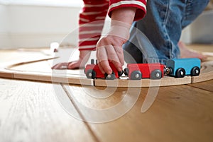 Child playing with toy wooden train