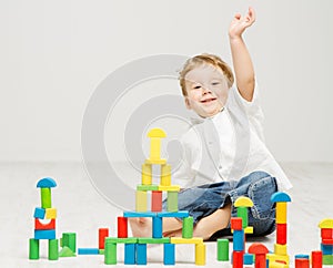 Child playing toys blocks over white