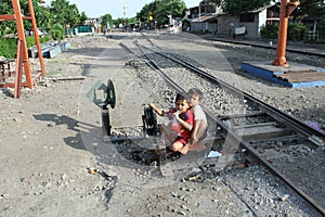 Child playing on train tracks at the station Sangkrah solo Central Java Indonesia.