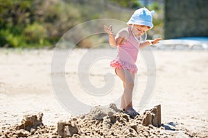 Child playing on tropical beach. Little girl digging sand at sea shore. Travel with young children