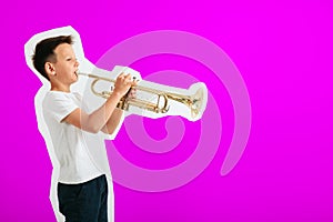 A child playing trumpet on turquoise background