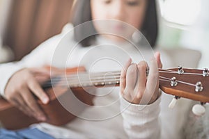 Child playing ukulele