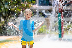 Child playing under tip bucket in water park