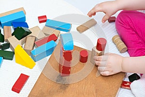 Child playing with vintage colorful wooden block toys