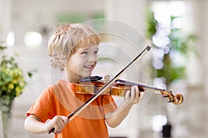 Child playing violin. Remote learning