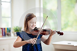 Child playing violin. Remote learning
