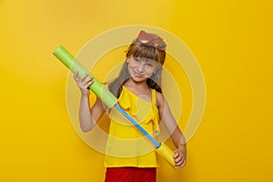 Child playing with water gun toy
