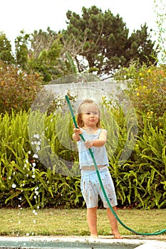 Child playing with water pipe