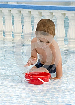 Child playing in water pool