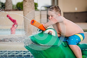 Child playing with water toy at kiddie pool