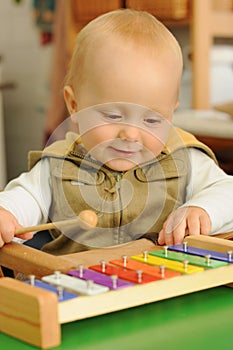 Child playing on xylophone photo