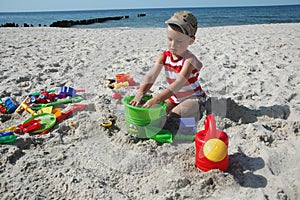 Child playint with toys on the beach