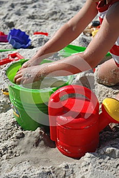 Child playint with toys on the beach