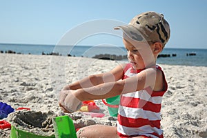 Child playint with toys on the beach