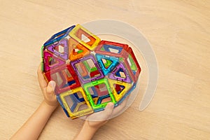 Child playng with colorful magnetic building blocks