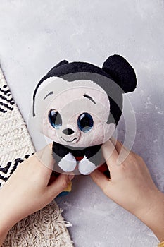 Child plays with adorable mickey mouse stuffed toy - cute and classic