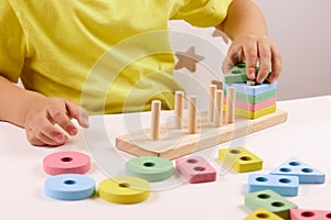 The child plays with colorful toy blocks. eco wooden toys. Little smart child playing natural toys. games for early
