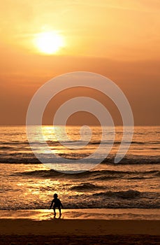 Child plays on the evening beach