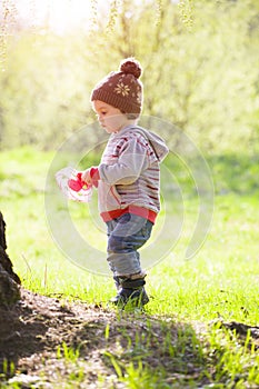 A child plays with a Frisbee outdoors.