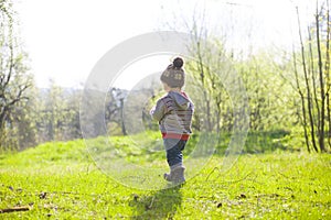 A child plays with a Frisbee outdoors.