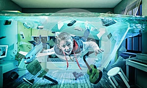 Child plays happy with an airplane in his flooded room