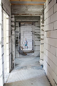 child plays in  hightower building construction site. little boy is alone in restricted danger area