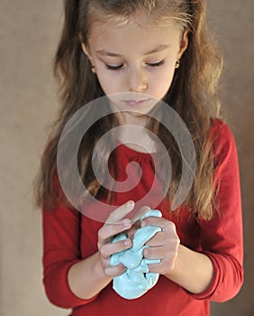 Child plays with home-made slime.