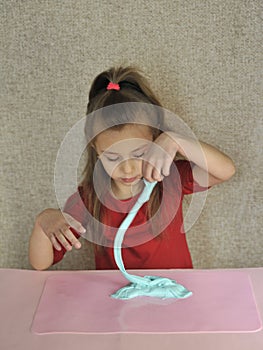 Child plays with home-made slime.