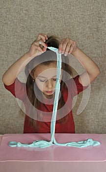 Child plays with home-made slime.