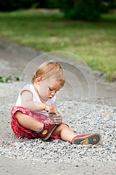 Child plays with pebbles