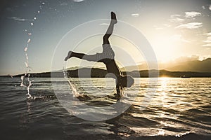 child plays and performs a capsize in the sea