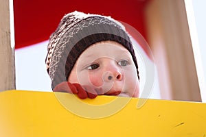 Child plays in the playground in spring