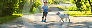 A child plays with a small dog in the park. Selective focus.