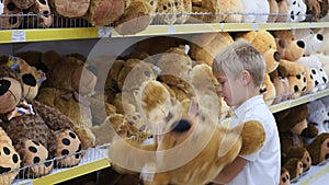 A child plays with a soft toy in the shop