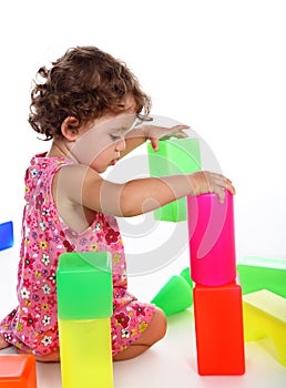 Child plays with toy blocks