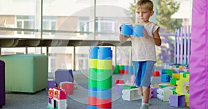 A child plays with toy building blocks in a children's recreational center