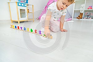 A child plays with a train made of numbers. Selective focus.
