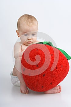 Child with plushy strawberry.