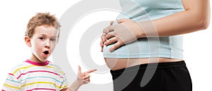 Child pointing his pregnant mother abdomen