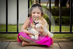 Child with Pomeranian Dog Outdoor