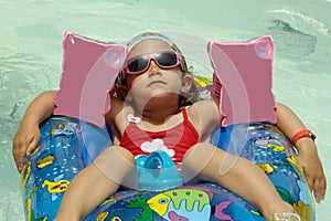 Child in pool relaxing