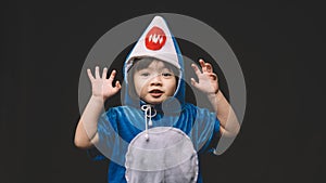 Child portrait with baby shark costume in studio