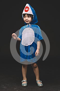 Child portrait with baby shark costume in studio